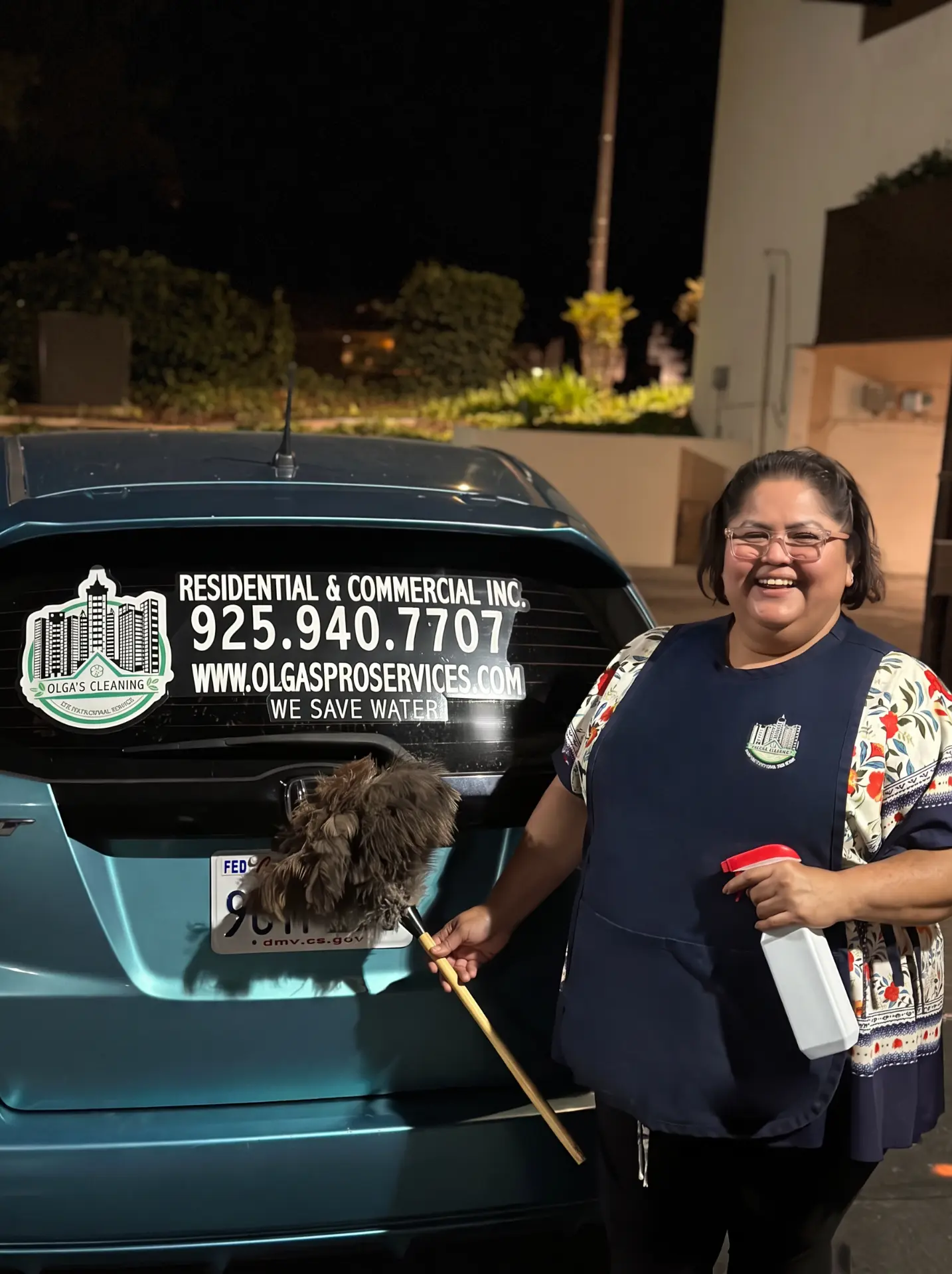 Olga Sanchez Hernandez, founder of Olga's Cleaning, standing beside the company vehicle